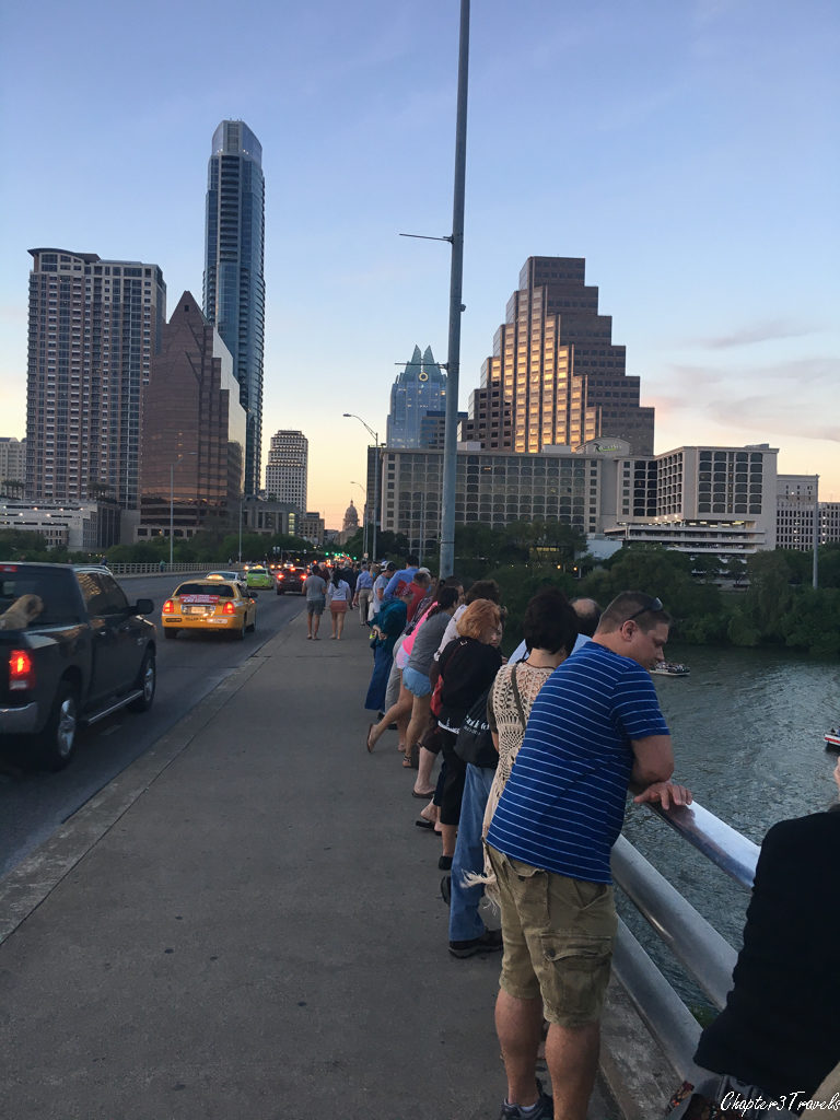 People standing on bridge.