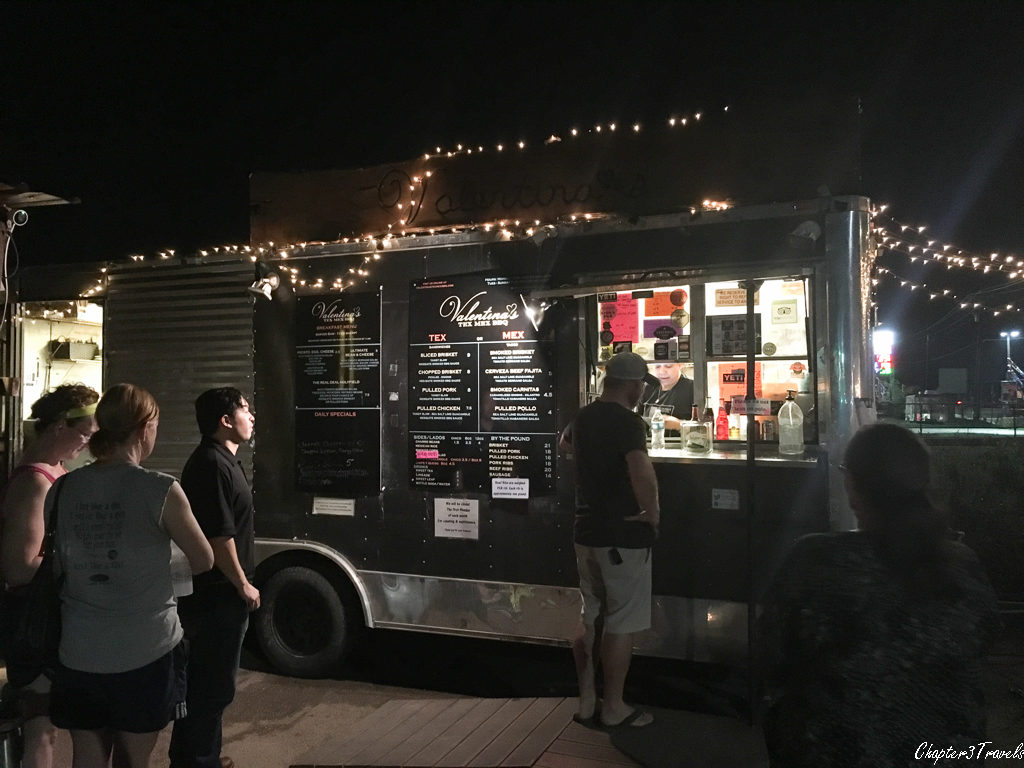 Several patrons in front of the food truck