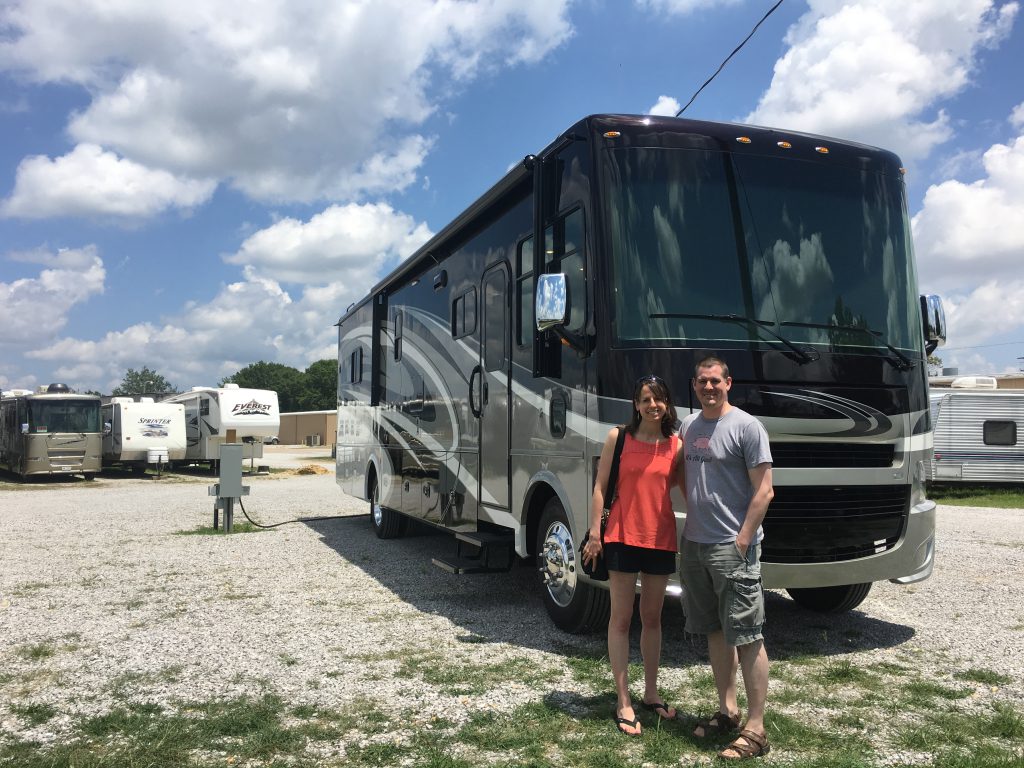 Kevin and Laura standing in front of their RV