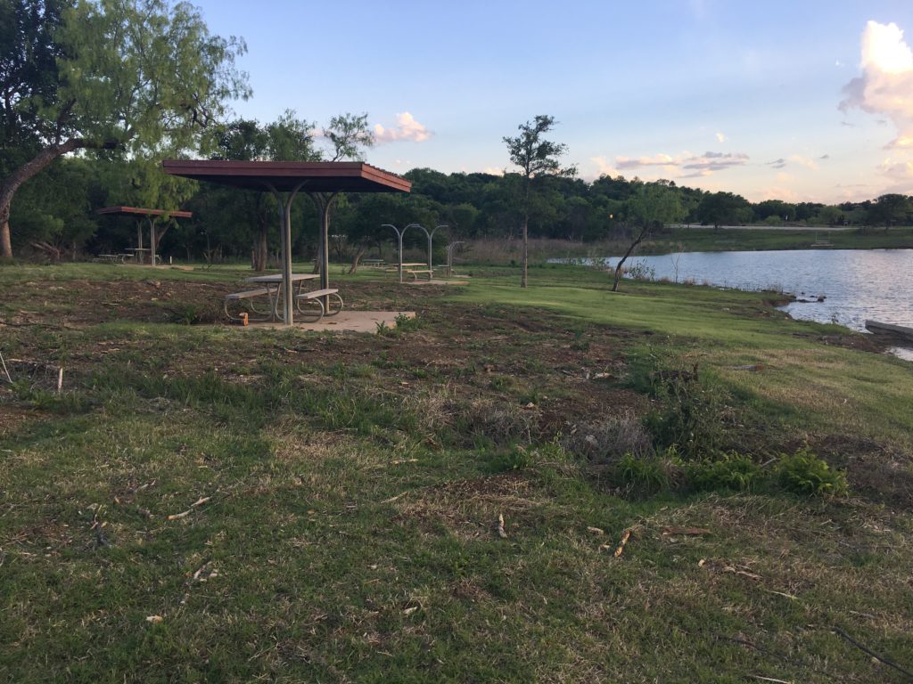 Picnic tables on bank of lake