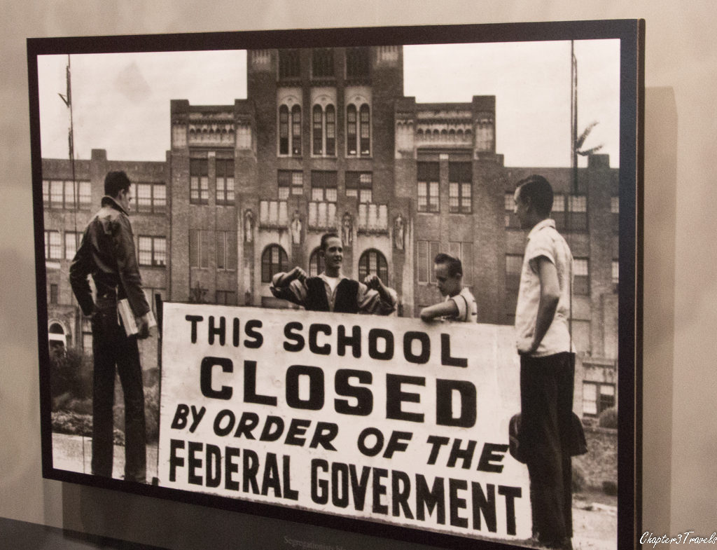 Photo of young men standing with sign in front of Central High School