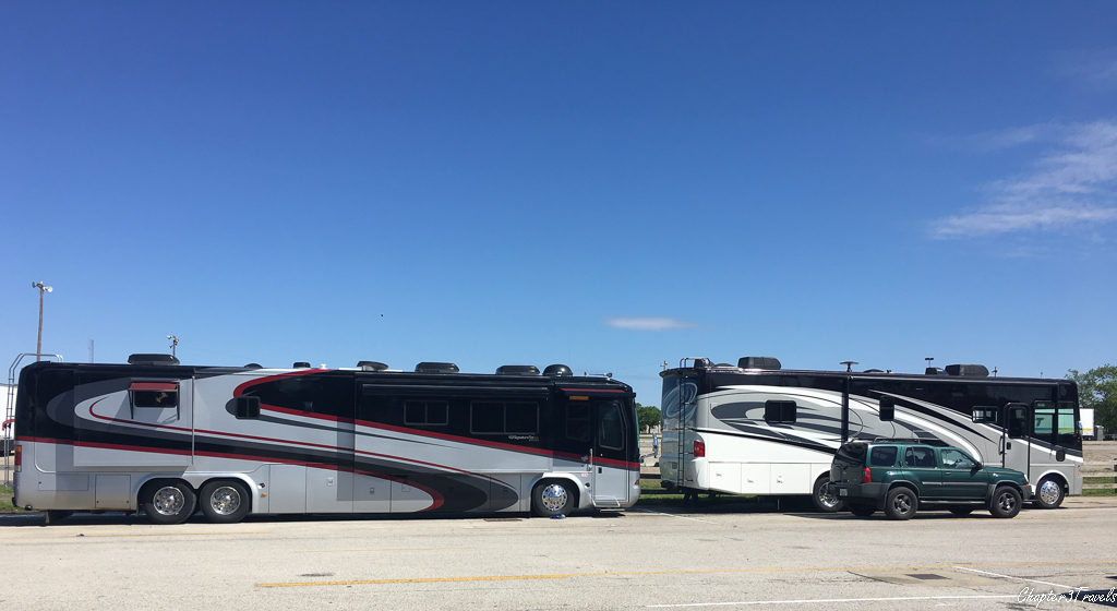 Large RV parked behind smaller RV