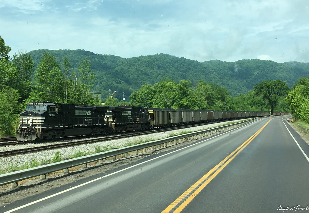 Coal train parked next to highway