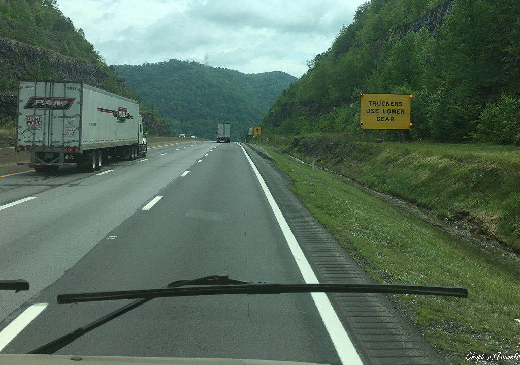 Mountain road with sign warning truckers to use lower gear