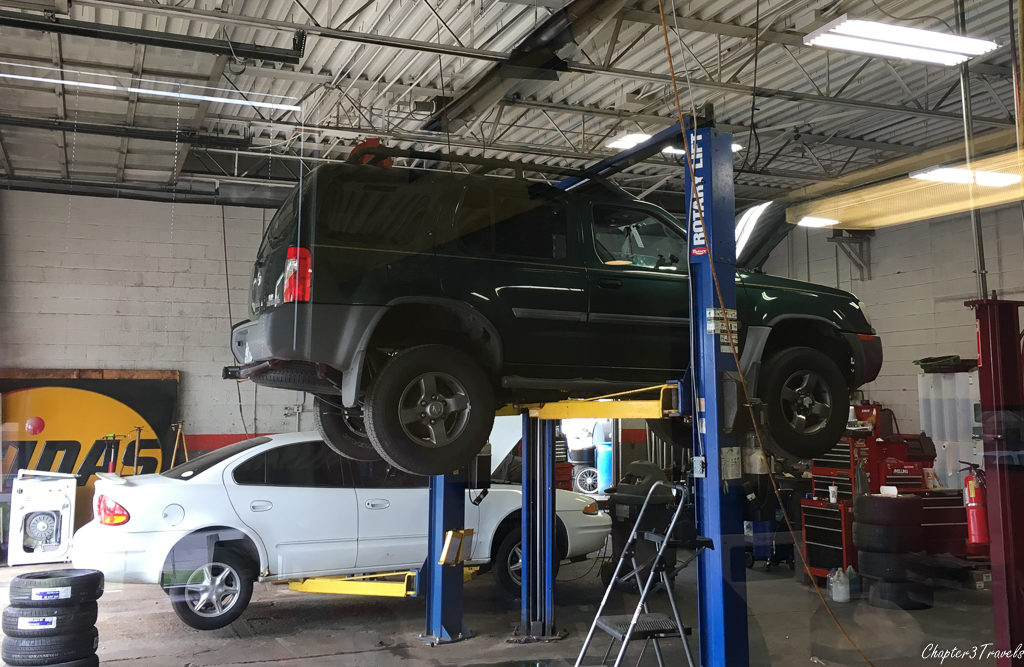 Nissan Xterra on car lift a Midas