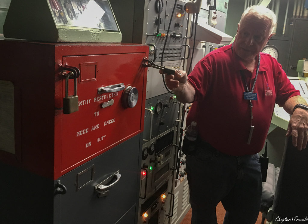 Tour guide pointing to locked cabinet which contained authentication cards at Titan Missile complex