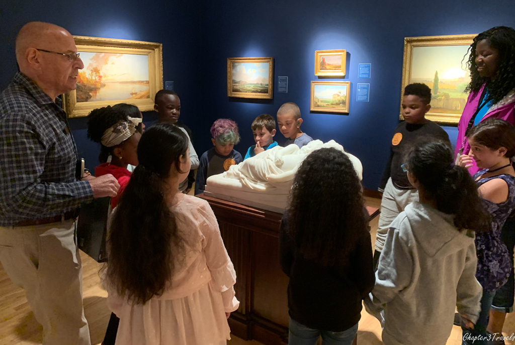 Kids looking at artwork at a museum
