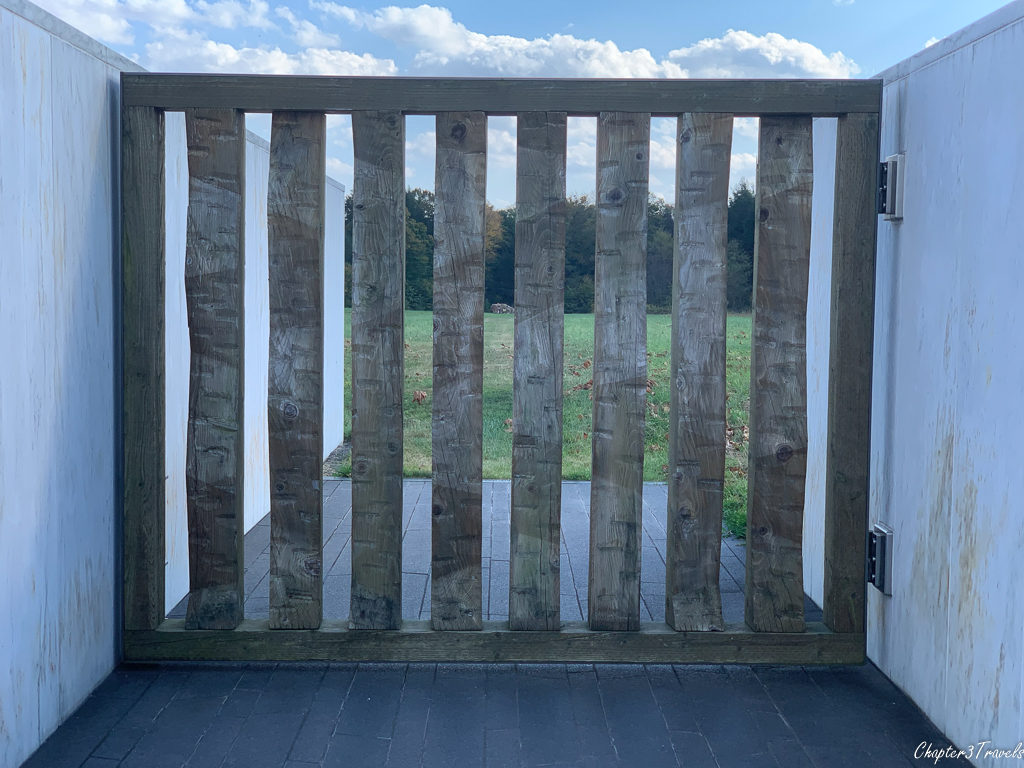 A gate at the end of the wall of names with views of the crash site